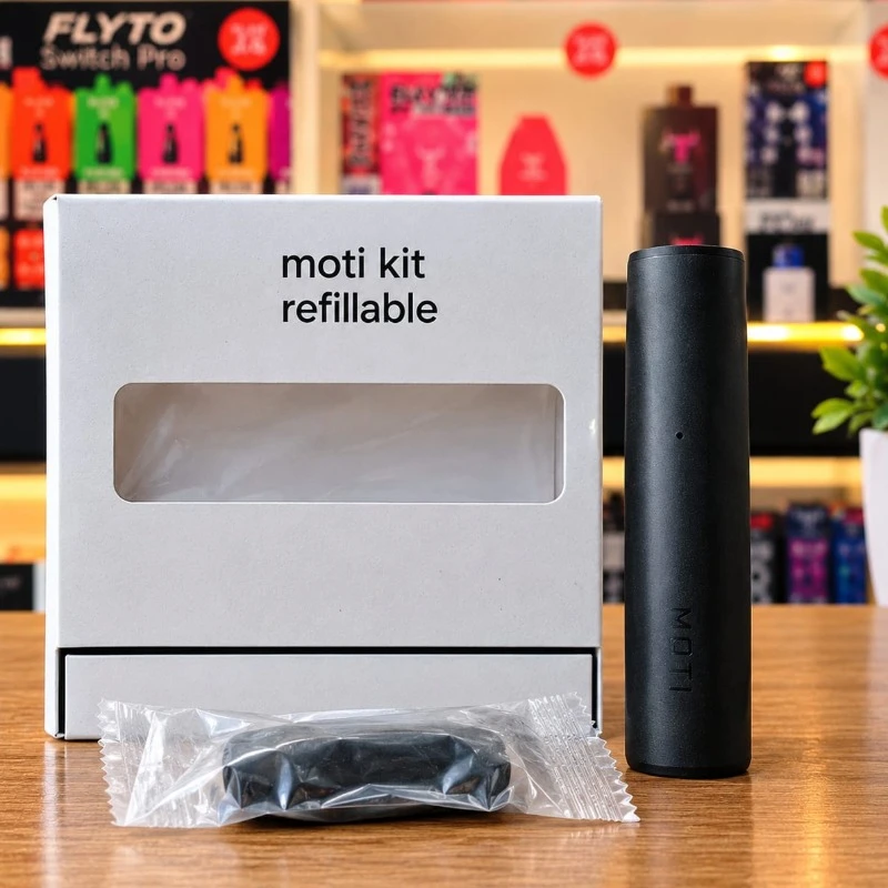 Black MOTI refillable kit pod device standing next to its white packaging box and sealed pod accessory at Likzomart